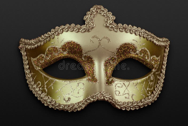 Artistic golden mask over a dark background. Artistic golden mask over a dark background