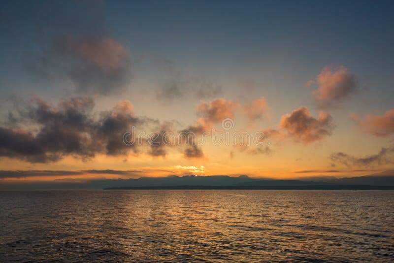 Guld- soluppgång bak fjällängberg och över sjön Leman royaltyfri fotografi Guld- soluppgång bak fjällängberg och över sjön Leman royaltyfri fotografi