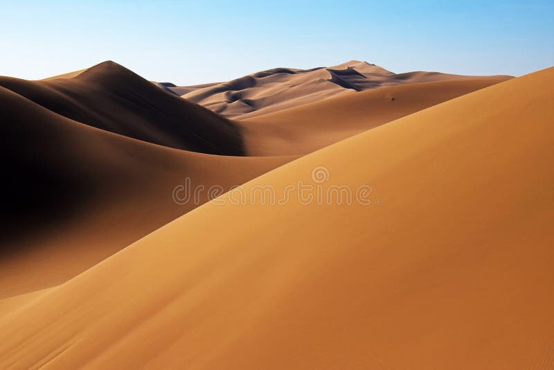 Beautiful landscape of golden sand dunes in central desert of Iran under blue sky , Maranjab desert near Kashan. Beautiful landscape of golden sand dunes in central desert of Iran under blue sky , Maranjab desert near Kashan