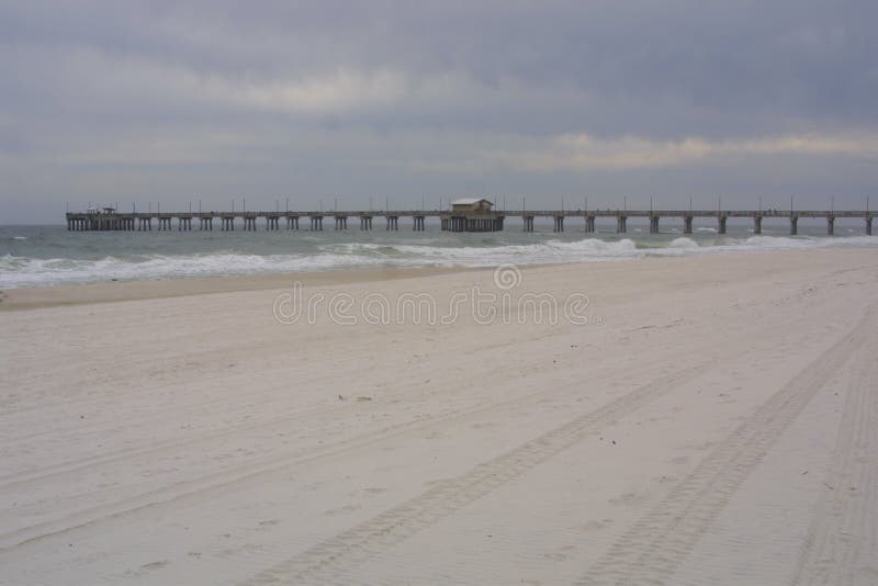 Gulf Shores Alabama Pier 2019. The cloudy day did not hurt the enjoyment of the beach in Gulf Shores, Alabama, USA the waves rolled in hour after hour. The royalty free stock photo Gulf Shores Alabama Pier 2019. The cloudy day did not hurt the enjoyment of the beach in Gulf Shores, Alabama, USA the waves rolled in hour after hour. The royalty free stock photo