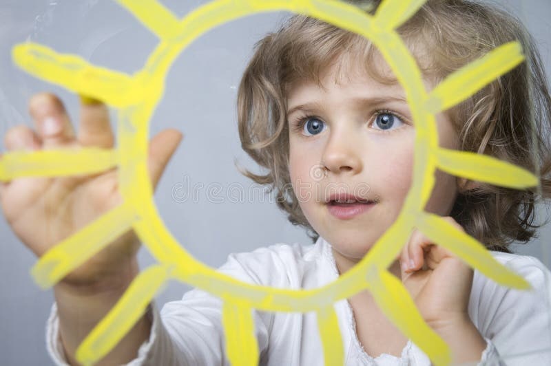 Söt flicka målar solen fotografering för bildbyråer