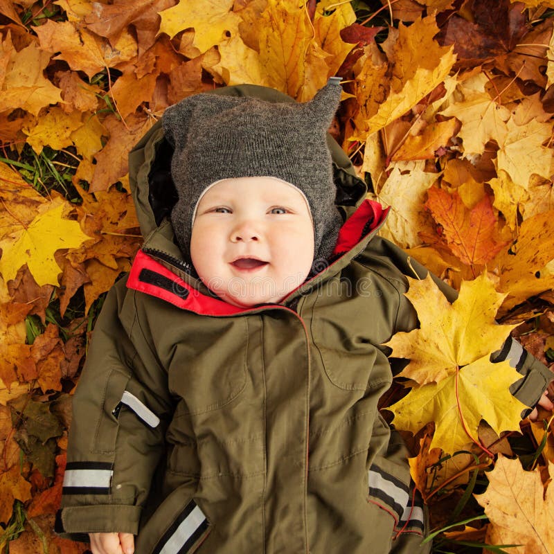 Cute Small Baby on Autumn Leaves. Happy Little Child 6 month old. Cute Small Baby on Autumn Leaves. Happy Little Child 6 month old