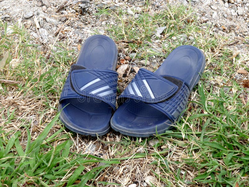 Rubber flip flops slide sandals men on ground. Rubber flip flops slide sandals men on ground