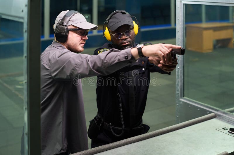 Giving Shooting Lessons at Indoor Gun Range stock photo