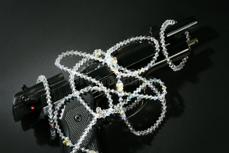 Gun and jewels over black, classic mafia image stock images