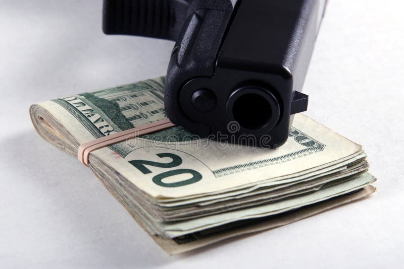 A semi-automatic pistol and a folded wad of money. A semi-automatic pistol and a folded wad of money