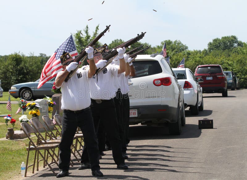 21 gun salute. Soldiers or veterans with guns and American flag prepare to shoot. Post 27 Honor Guard. Sallisaw City Cemetery, Sallisaw, Oklahoma, Memorial Day, May 29, 2017 during Memorial Day services or program. 21 gun salute. Soldiers or veterans with guns and American flag prepare to shoot. Post 27 Honor Guard. Sallisaw City Cemetery, Sallisaw, Oklahoma, Memorial Day, May 29, 2017 during Memorial Day services or program.