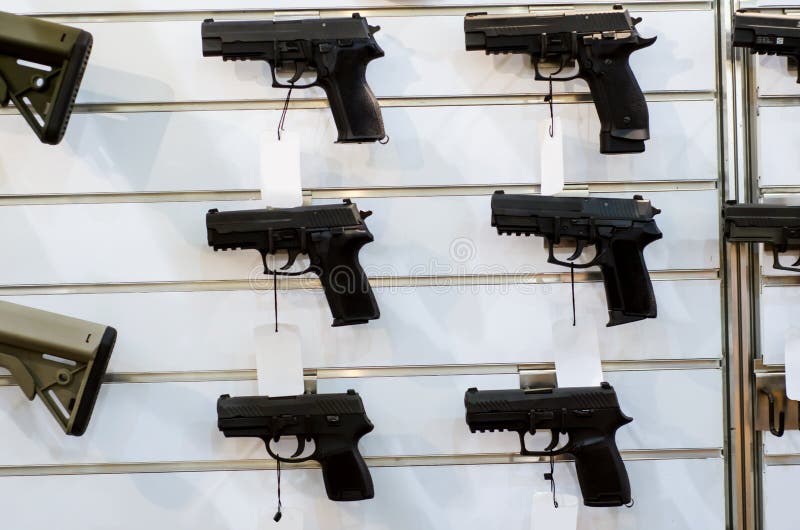 Gun wall rack with pistol stock photo. Image of black 141018808