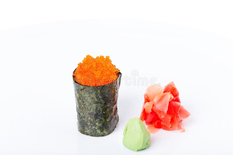 Gunkan sushi stuffed with red tobiko caviar. Served with heap of ginger and wasabi. Macro. Can be used as a whole background royalty free stock images Gunkan sushi stuffed with red tobiko caviar. Served with heap of ginger and wasabi. Macro. Can be used as a whole background royalty free stock images