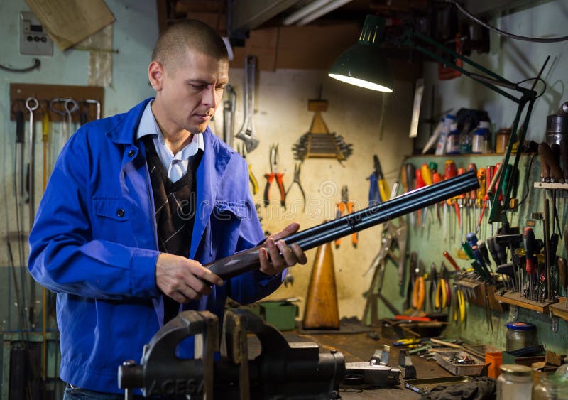 Gunsmith Assembling Shotgun after Diagnostics and Repair in Weapons