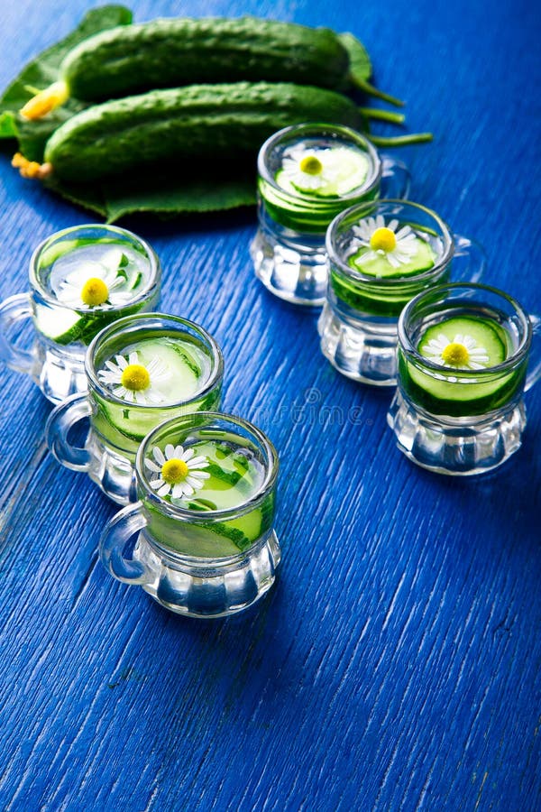 Gurkenwasser in sechs kleinem Maurerglasgefäß auf blauem Hintergrund rustic detox lizenzfreie stockbilder Gurkenwasser in sechs kleinem Maurerglasgefäß auf blauem Hintergrund rustic detox lizenzfreie stockbilder