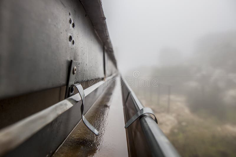 Gutter drainage system on the roof with dripping fog stock image Gutter drainage system on the roof with dripping fog stock image
