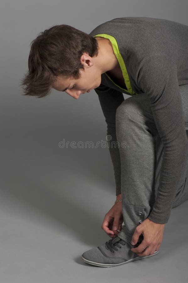 Guy adjusts his shoes stock image. Image of person, adjusts 31444095