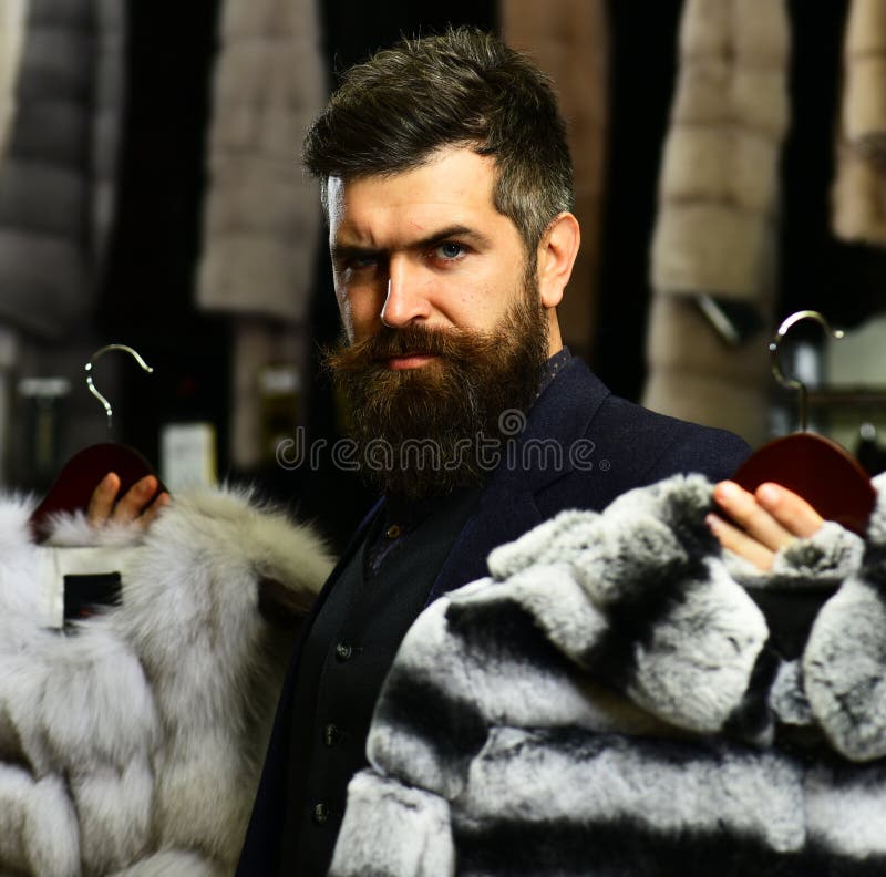 Guy with Beard Chooses Furry Coats. Rich Fashion Concept Stock Photo ...