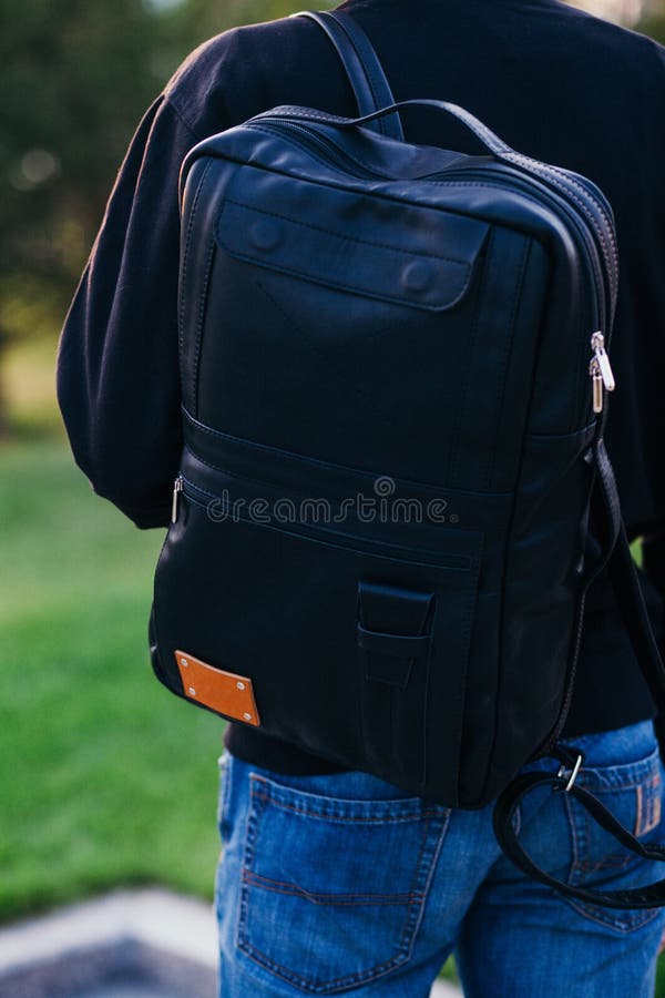 The Guy with a Black Leather Backpack. City Landscape Stock Photo