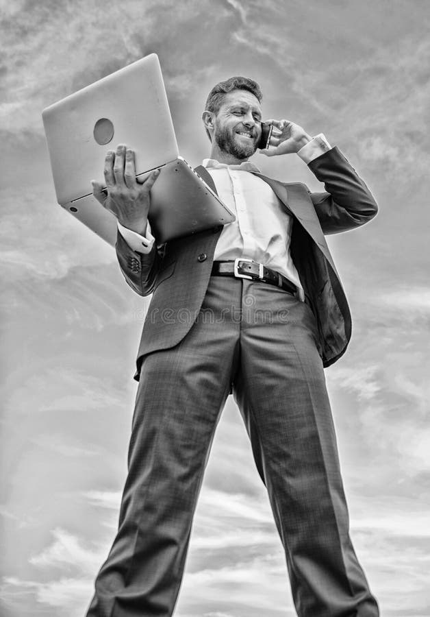 Guy formal suit modern technology manager entrepreneur answer phone call. Man well groomed businessman holds laptop stock photo Guy formal suit modern technology manager entrepreneur answer phone call. Man well groomed businessman holds laptop stock photo