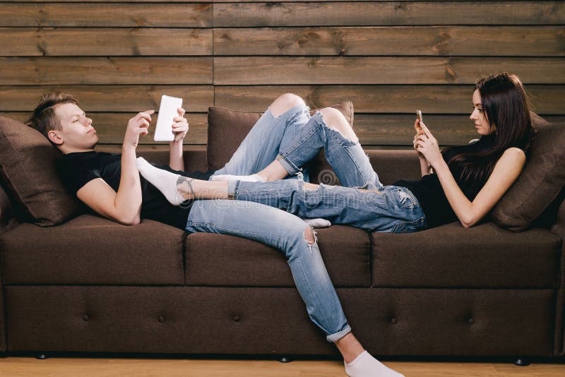 Guy and girl using phone and tablet