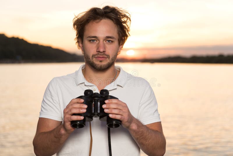 Men with binocularus in his handds on the yacht royalty free stock images