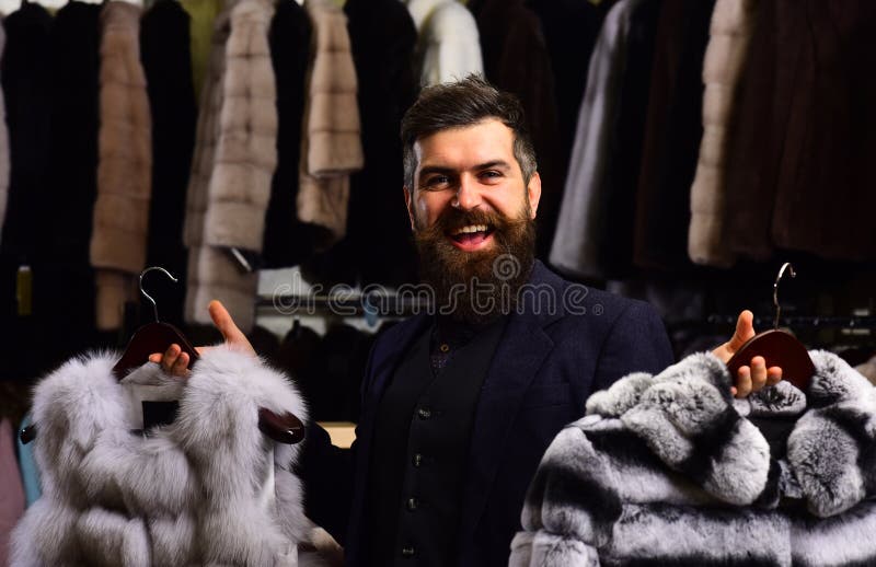 Guy with Happy Face Shows Fur Coats in Fashion Store. Stock Photo ...