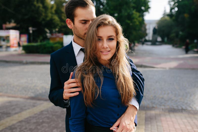 Guy hugging his girlfriend stock photo. Image of outdoors - 64178296