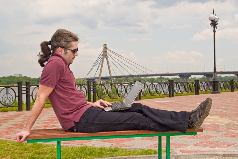 Guy with laptop in the park