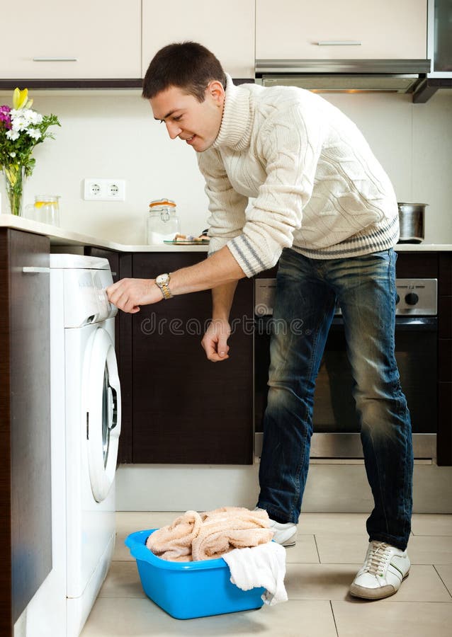 Guy Loading the Washing Machine Stock Photo Image of holding, smiling
