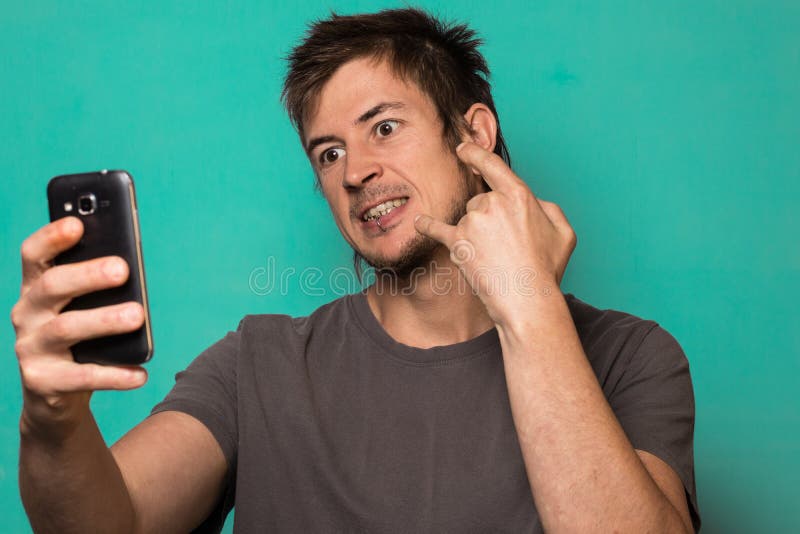 Guy Making a Selfie with Funny Faces. Guy Taking Pictures with His