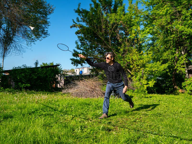 Guy Play Badminton Outdoors on a Beautiful Summer Day Stock Image