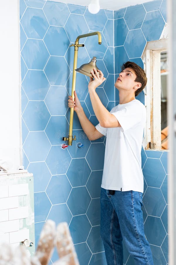Guy Preparing New Shower for Installation in Building Under