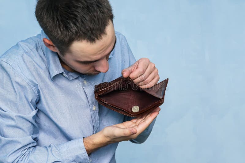 Sad man with empty purse on white background Stock Photo - Alamy