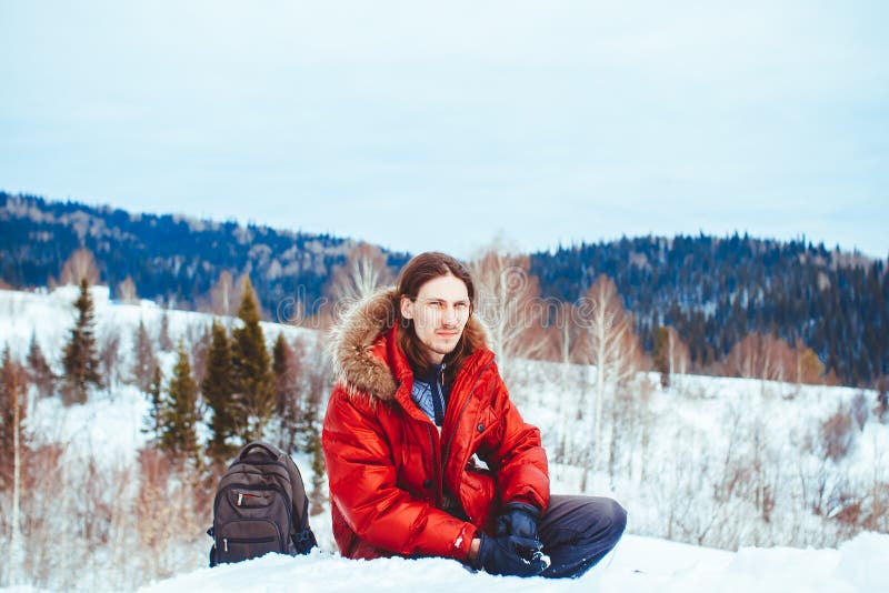 The guy sitting in the snow stock image