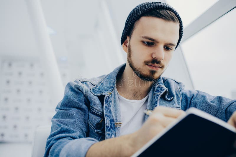 Guy is Sitting on Sofa and Writing Notes Stock Image Image of hipster