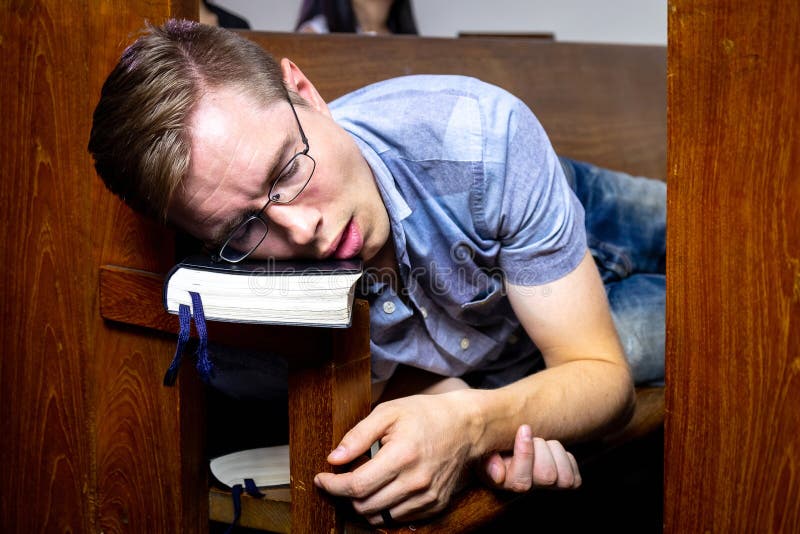 Guy Sleeping on the Church Bench While in the Church.