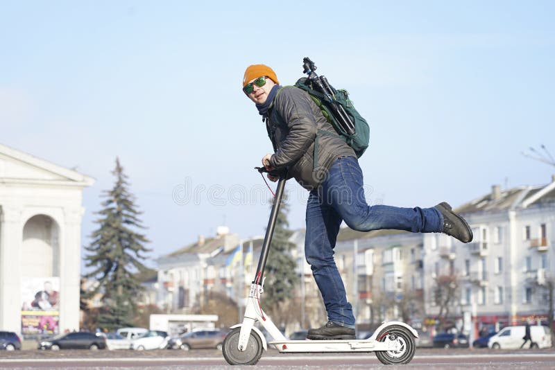 The Guy Stands with One Foot on an Electric Scooter Stock Photo Image