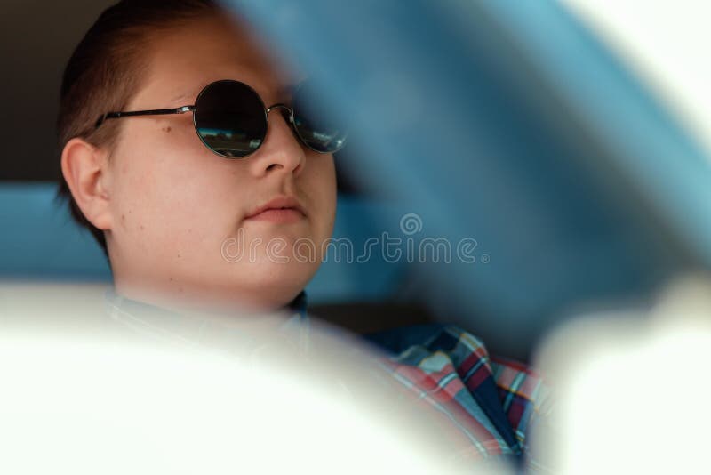 The Guy in Sunglasses Sitting in the Car Driving Stock Photo Image of hair, serious 147648444