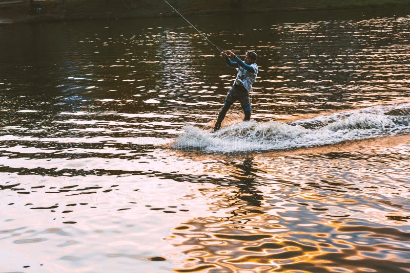 The guy on the Wakeboard rides on the river at sunset. Krasnogorsk, Russia - 08.09.2019 royalty free stock images The guy on the Wakeboard rides on the river at sunset. Krasnogorsk, Russia - 08.09.2019 royalty free stock images