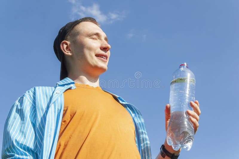 https://thumbs.dreamstime.com/b/guy-water-bottle-against-sky-smiling-young-his-hand-lower-angle-close-up-159207436.jpg
