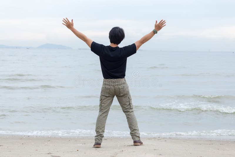 Guy Wearing Cargo Pants and Standing on the Beach Stock Photo Image