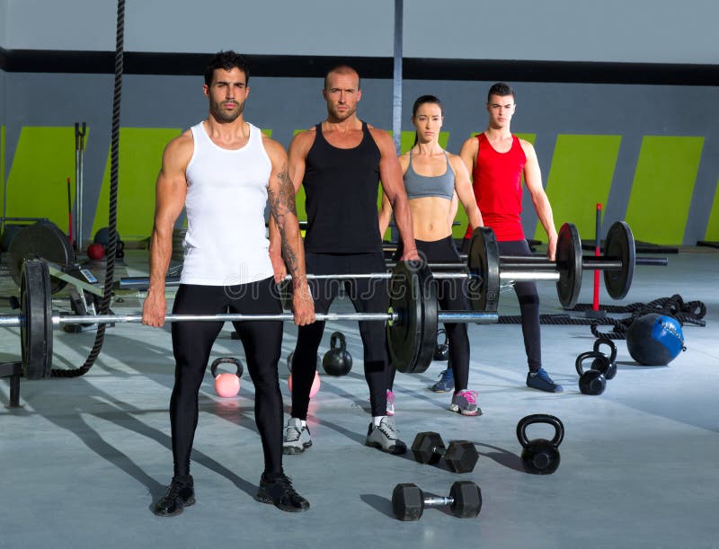Gym group with weight lifting bar crossfit workout stock photos Gym group with weight lifting bar crossfit workout stock photos