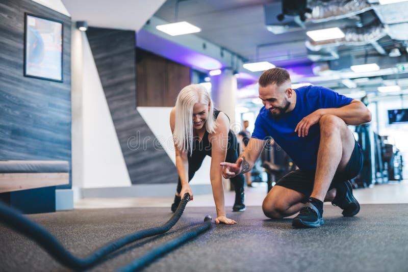 Gym instructor and a woman exercising at the gym. stock images Gym instructor and a woman exercising at the gym. stock images
