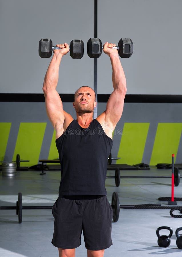 Gym man with dumbbells exercise crossfit