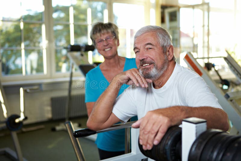 Two happy senior people together in a gym. Two happy senior people together in a gym