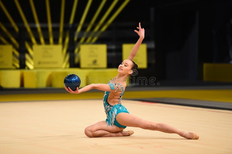 Gymnast girl perform at rhythmic gymnastics competition