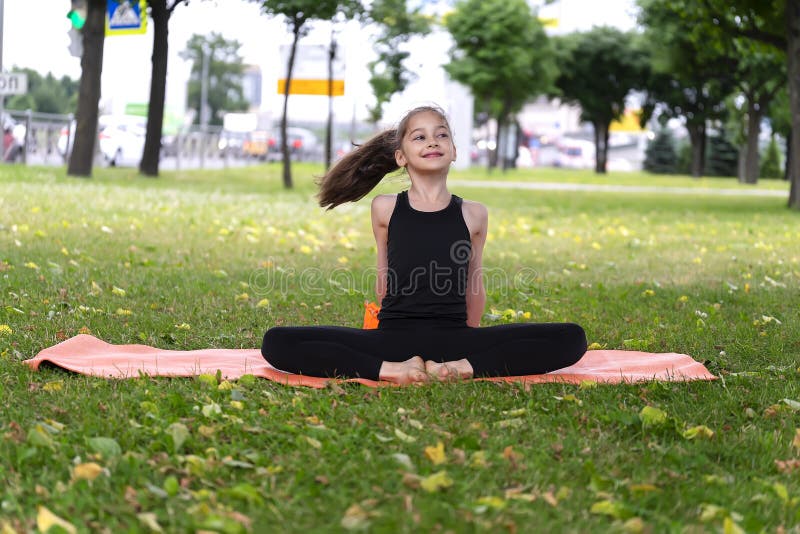 Gymnast Schoolgirl Warming Up in a Grass Park before Performing Complex ...