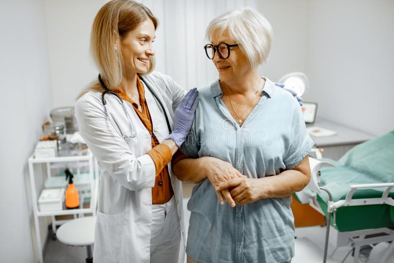 Gynecologist taking care of a senior women patient, supporting and cheering her after the examination in the gynecological office. Gynecologist taking care of a senior women patient, supporting and cheering her after the examination in the gynecological office