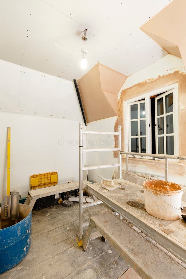 Gypsum plasterboard drywall installation in UK home interior. Gypsum plasterboard installation in home interior renovation with plastering tools, UK royalty free stock image Gypsum plasterboard drywall installation in UK home interior. Gypsum plasterboard installation in home interior renovation with plastering tools, UK royalty free stock image