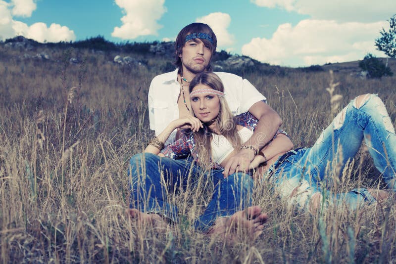 Beautiful young couple hippie posing together over picturesque landscape. Beautiful young couple hippie posing together over picturesque landscape.