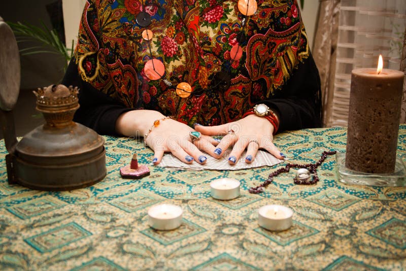 Gypsy fortune-teller laid out the cards on the table next to candles, bahur and other magical paraphernalia, woman, tarot, female, witch, future, mysterious, paranormal, blank, predict, psychic, oracle, divination, mystic, revulsion, background, wizard, fortuneteller, destiny, fate, foresight, astrology, genie, adult, charmer, fantasy, fingers, forecast, foretell, hands. Gypsy fortune-teller laid out the cards on the table next to candles, bahur and other magical paraphernalia, woman, tarot, female, witch, future, mysterious, paranormal, blank, predict, psychic, oracle, divination, mystic, revulsion, background, wizard, fortuneteller, destiny, fate, foresight, astrology, genie, adult, charmer, fantasy, fingers, forecast, foretell, hands