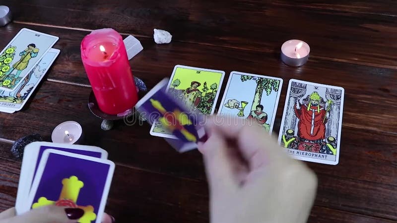 A Gypsy fortune-teller plays solitaire and reads Tarot cards by candlelight. Predictions of fate and a magical session on the card