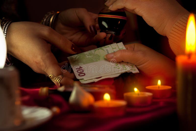 Gypsy woman taking a money from her customer for magic potion royalty free stock images Gypsy woman taking a money from her customer for magic potion royalty free stock images